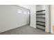 Bright bedroom featuring neutral carpet and white walls, complemented by modern built-in shelving and windows at 747 Ralph Mcgill Ne Blvd # 337, Atlanta, GA 30312