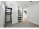 Bedroom featuring neutral carpet, white walls, built-in shelving and a doorway leading to the staircase at 747 Ralph Mcgill Ne Blvd # 337, Atlanta, GA 30312