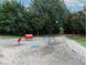 Dog park with pet play equipment and gravel surface, surrounded by mature trees and greenery at 747 Ralph Mcgill Ne Blvd # 337, Atlanta, GA 30312