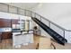Open-concept living area with high ceilings, modern fixtures, stainless appliances, and staircase at 747 Ralph Mcgill Ne Blvd # 337, Atlanta, GA 30312