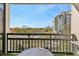 Relaxing balcony view with city skyline, green trees, and outdoor seating at 1130 Piedmont Ne Ave # 907, Atlanta, GA 30309