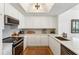 Bright kitchen with white cabinets, stainless steel appliances, and modern countertops at 1130 Piedmont Ne Ave # 907, Atlanta, GA 30309