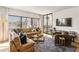 This living room offers expansive windows with views, lots of comfortable seating, and ample square footage at 1130 Piedmont Ne Ave # 907, Atlanta, GA 30309