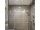 Sleek, modern bathroom shower with gray tile, chrome fixtures, and glass door at 1130 Piedmont Ne Ave # 907, Atlanta, GA 30309