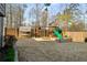 Spacious backyard with a wooden playset, swing, and sandbox, perfect for outdoor fun at 1354 Larson Sw Ct, Marietta, GA 30064