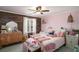 Pink bedroom featuring a wood accent wall, plush bedding, and ample natural light at 1354 Larson Sw Ct, Marietta, GA 30064