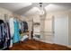 Walk-in closet with hardwood floors, shelving, clothing racks, and a decorative chandelier at 1354 Larson Sw Ct, Marietta, GA 30064