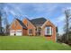 Charming brick home features an attached two-car garage and well-manicured lawn at 1354 Larson Sw Ct, Marietta, GA 30064