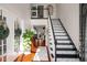 Bright foyer with high ceilings features a staircase with decorative treads and rich hardwood floors at 1354 Larson Sw Ct, Marietta, GA 30064