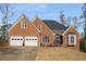 Brick home with a two-car garage, well-maintained lawn, and inviting entrance at 1354 Larson Sw Ct, Marietta, GA 30064