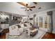 Bright living room featuring hardwood floors, a ceiling fan, and a large window for ample natural light at 1354 Larson Sw Ct, Marietta, GA 30064