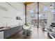 Bright community gym with fitness equipment, kitchenette, and large windows overlooking the pool at 1661 La France Ne St # 102, Atlanta, GA 30307