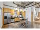 Modern kitchen with stainless steel appliances, island with seating, and industrial ceiling at 1661 La France Ne St # 102, Atlanta, GA 30307
