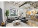 Bright living room features industrial ceiling, large windows, and contemporary decor at 1661 La France Ne St # 102, Atlanta, GA 30307