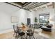 Bright open-concept living and dining space with exposed beams, concrete floors, and modern decor at 1661 La France Ne St # 102, Atlanta, GA 30307