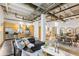 Bright, open-concept living space with stainless steel appliances, kitchen island, and exposed beams at 1661 La France Ne St # 102, Atlanta, GA 30307