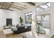 Bright living room featuring an industrial ceiling and an adjacent kitchen area at 1661 La France Ne St # 102, Atlanta, GA 30307