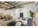 Spacious living area with a comfortable black leather couch, dining space, and minimalist decor at 1661 La France Ne St # 102, Atlanta, GA 30307