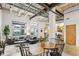 Open-concept living space with kitchen, dining, and living areas featuring exposed beams and concrete floors at 1661 La France Ne St # 102, Atlanta, GA 30307