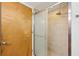 Modern bathroom shower with glass door and neutral tile at 1661 La France Ne St # 102, Atlanta, GA 30307