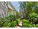 Landscaped backyard with a stone path, lush greenery, and views of the home at 2687 Ashford Ne Rd, Brookhaven, GA 30319
