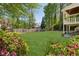A spacious backyard features a well-manicured lawn, mature trees, and a wooden fence at 2687 Ashford Ne Rd, Brookhaven, GA 30319