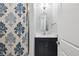 Stylish bathroom featuring a vanity with marble countertop and patterned shower curtain at 2687 Ashford Ne Rd, Brookhaven, GA 30319