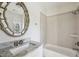 Bright bathroom with a granite countertop, white cabinets and shower-over-tub at 2687 Ashford Ne Rd, Brookhaven, GA 30319