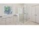 Modern bathroom featuring a glass shower, granite countertops, and ample storage in the white cabinets at 2687 Ashford Ne Rd, Brookhaven, GA 30319