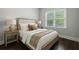 Cozy bedroom featuring a comfortable bed, soft lighting, and dark wood floors at 2687 Ashford Ne Rd, Brookhaven, GA 30319
