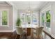 Cozy dining area with a round table, stylish chairs, modern lighting, and sliding doors to the outside at 2687 Ashford Ne Rd, Brookhaven, GA 30319