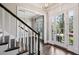 Inviting foyer with hardwood floors, staircase, and a view into the dining room at 2687 Ashford Ne Rd, Brookhaven, GA 30319
