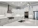 Well-equipped kitchen with stainless steel appliances, marble countertops, and sleek white cabinetry at 2687 Ashford Ne Rd, Brookhaven, GA 30319
