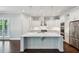 Bright kitchen featuring white cabinets, a large island with marble countertop, and stainless appliances at 2687 Ashford Ne Rd, Brookhaven, GA 30319