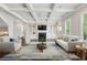 Spacious living room with coffered ceilings, built-in shelves, and a comfortable seating area with plush furniture at 2687 Ashford Ne Rd, Brookhaven, GA 30319