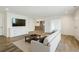 Spacious living room with hardwood floors, white shiplap walls, and a view into the kitchen at 2687 Ashford Ne Rd, Brookhaven, GA 30319