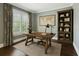 Cozy home office with a wooden desk, built-in shelving, and a large window at 2687 Ashford Ne Rd, Brookhaven, GA 30319