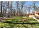 Beautiful backyard featuring a well-maintained lawn, a shed and mature trees surrounding the property at 5836 Trailwoods Ct, Stone Mountain, GA 30087