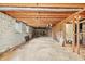 Unfinished basement space with exposed ceiling beams and concrete flooring offers potential for customization at 5836 Trailwoods Ct, Stone Mountain, GA 30087