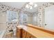 This bathroom offers ample vanity space with a sink, complemented by floral wallpaper at 5836 Trailwoods Ct, Stone Mountain, GA 30087