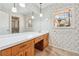 Bathroom vanity with mirror, white countertop, and floral wallpaper at 5836 Trailwoods Ct, Stone Mountain, GA 30087