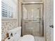 Bathroom with glass shower, floral wallpaper, and toilet at 5836 Trailwoods Ct, Stone Mountain, GA 30087