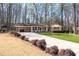 Traditional home with a well-manicured lawn, long driveway, and attractive landscaping in a tranquil setting at 5836 Trailwoods Ct, Stone Mountain, GA 30087