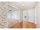 Interior hallway with hardwood floors, decorative wallpaper, and access to various rooms in the home at 5836 Trailwoods Ct, Stone Mountain, GA 30087