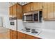 Close-up of the kitchen appliances and floral wallpaper accents at 5836 Trailwoods Ct, Stone Mountain, GA 30087