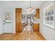 Traditional kitchen with wooden cabinets, hardwood floors, and a view to the exterior at 5836 Trailwoods Ct, Stone Mountain, GA 30087