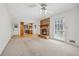 Inviting living space with fireplace, ceiling fan, and easy access to the kitchen and outdoor patio at 5836 Trailwoods Ct, Stone Mountain, GA 30087