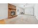 Cozy living room features a brick fireplace, ceiling fan, and access to the backyard through a glass door at 5836 Trailwoods Ct, Stone Mountain, GA 30087