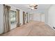 Spacious living room with large windows, neutral carpet, and traditional decor, offering ample natural light at 5836 Trailwoods Ct, Stone Mountain, GA 30087