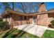 A brick house with a concrete patio, offering a comfortable outdoor space for relaxation and entertainment at 5836 Trailwoods Ct, Stone Mountain, GA 30087